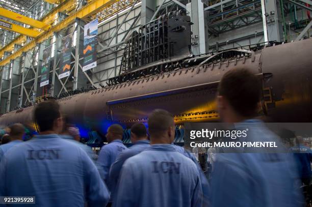 Workers walk beside the Brazilian Riachuelo Class Submarine during the event announcing the beginning of the final stage of the submarine...