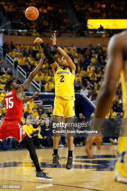 Michigan Wolverines guard Jordan Poole shoots a jump shot over Ohio State Buckeyes guard Kam Williams during a regular season Big 10 Conference...