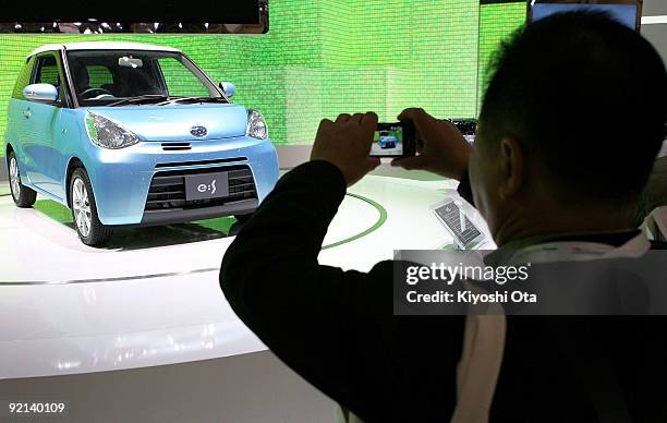 Visitor takes pictures of the new Daihatsu Motor Co.'s concept vehicle 'e:S' during the 41st Tokyo Motor Show at Makuhari Messe on October 21, 2009...