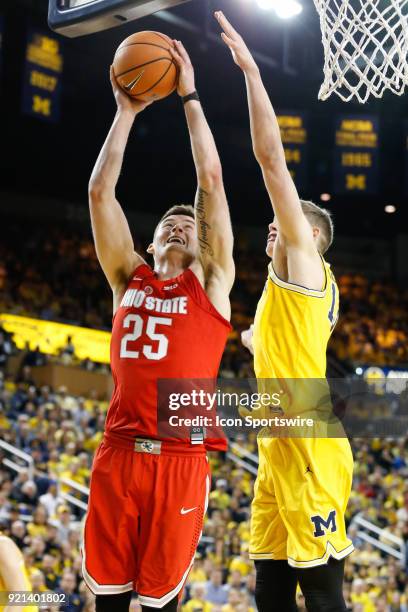 Ohio State Buckeyes forward Kyle Young goes in for a layup against Michigan Wolverines forward Moritz Wagner during a regular season Big 10...