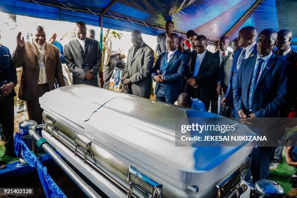 Members of the Movement for Democratic Change party pay their respects around the coffin of Morgan Tsvangirai during the burial of Zimbabwe's iconic...