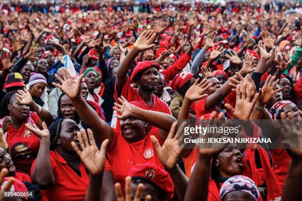 Mourners and supporters of the Movement for Democratic Change party wave good bye to Zimbabwe's iconic opposition leader Morgan Tsvangirai who died...
