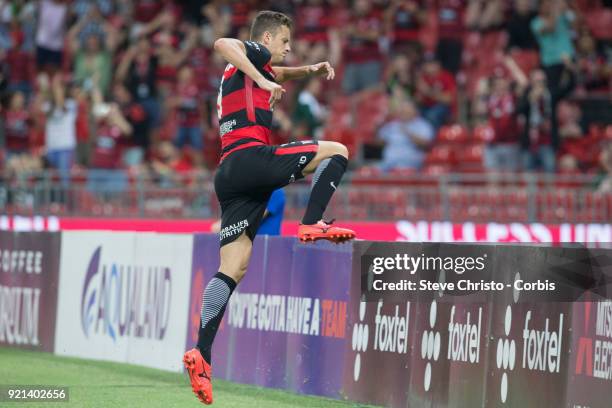 Oriol Riera of the Wanderers celebrates kicking a goal by leaping the signage during the round one A-League match between the Western Sydney...