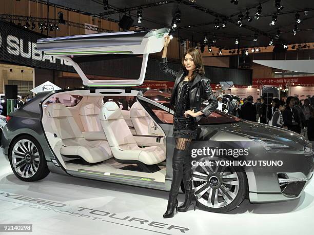 Model stands by a new Subaru concept vehicle, made by Japanese auto maker Fuji Heavy Industries, called the Subaru Hybrid Tourer Concept, with a 2.0...