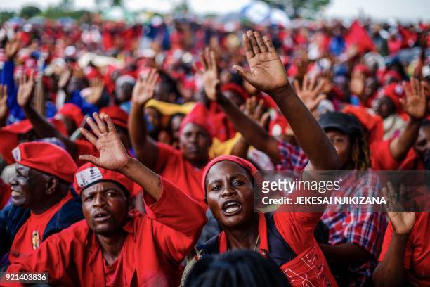 Mourners and supporters of the Movement for Democratic Change party wave good bye to Zimbabwe's iconic opposition leader Morgan Tsvangirai who died...