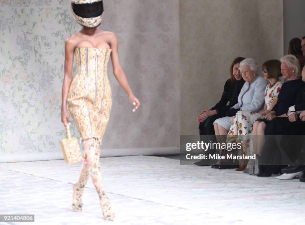 Queen Elizabeth II attends the Richard Quinn show with Chief Executive of the British Fashion Council Caroline Rush and Conde Nast Artistic Director...