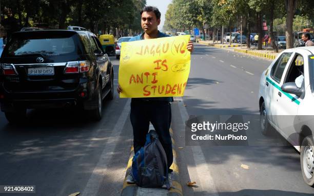 Jawarharlal Nehru University student holds a poster calling JNU Vice Chancellor Jagadesh Kumar as &quot;anti-student&quot; during a march in protest...