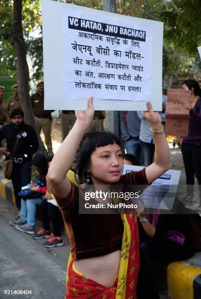 Jawarharlal Nehru University student holds a placard demanding the removal of their university Vice Chancellor Jagadesh Kumar. JNU students gather to...