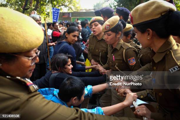 Jawarharlal Nehru University students push against Delhi police officials as they stop their march towards Ministry of Human Resource Development in...