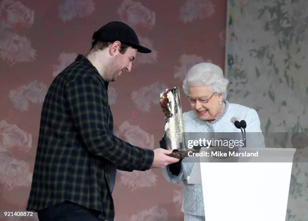 Queen Elizabeth II and Richard Quinn attend the Richard Quinn show during London Fashion Week February 2018 at BFC Show Space on February 20, 2018 in...