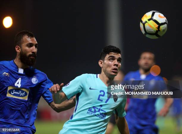 Saudi club Al-Hilal's Achraf Bencharki fights for the ball with Roozbeh Cheshmi of Iranian club Esteghlal during their Asian Champions League...