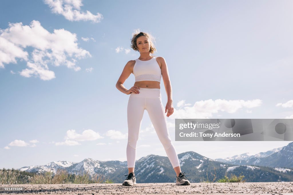 Young woman in workout clothing in mountain setting