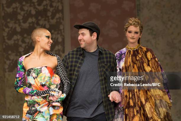 Designer Richard Quinn walks the show finale with model Adwoa Aboah of the Richard Quinn show during London Fashion Week February 2018 at BFC Show...