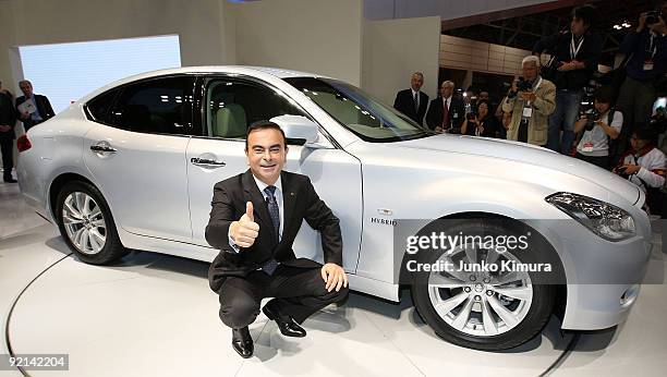 Nissan's CEO Carlos Ghosn introduces the company's electric vehicle Fuga Hybrid during the 41st Tokyo Motor Show at Makuhari Messe on October 21,...
