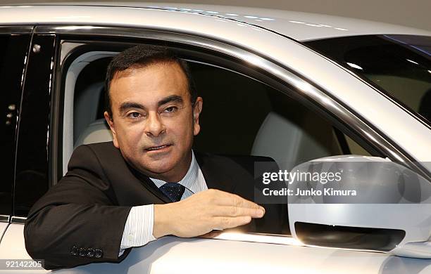 Nissan's CEO Carlos Ghosn introduces the company's electric vehicle Fuga Hybrid during the 41st Tokyo Motor Show at Makuhari Messe on October 21,...