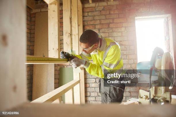 male carpenter with chopsaw - builder apprenticeship stock pictures, royalty-free photos & images