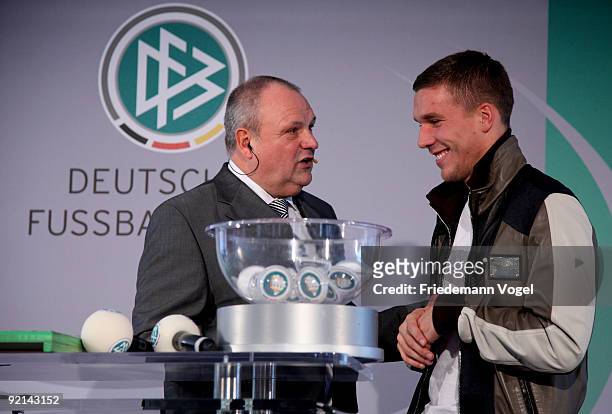 Lukas Podolski of FC Koeln and DFB spokesman Harald Stenger talk drawing the Women's DFB Cup round of sixteen matches during the DFB press conference...