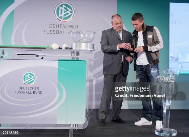 Lukas Podolski of FC Koeln and DFB spokesman Harald Stenger draw the Women's DFB Cup round of sixteen matches during the DFB press conference for the...