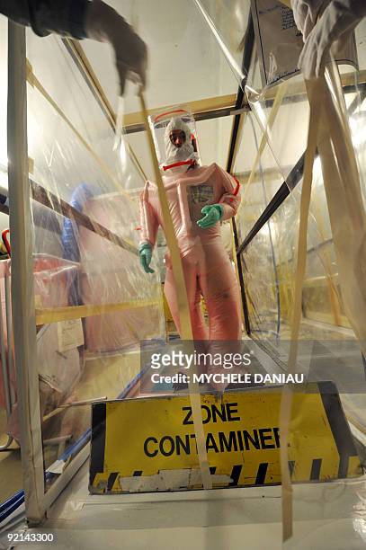 Man wears a protective suit on October 14, 2009 before visiting a contaminated area at the French electricity group EDF nuclear plant in Flamanville,...