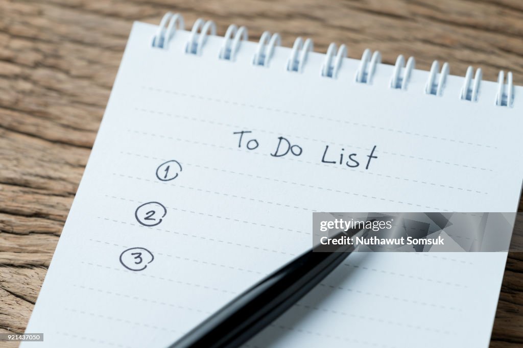 To do or writing tasks priority concept, closed up of list on numbers with pen and headline as To Do List on white paper notepad on wood table in soft tone