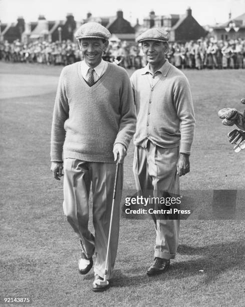 American golfer Ben Hogan pats W. J. Branch on the back as they leave the 18th green at the end of their qualifying rounds in the Open Golf...