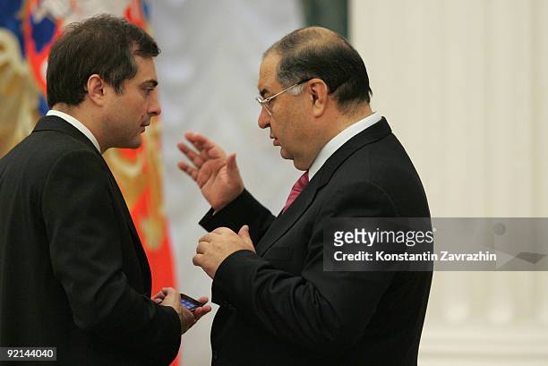 Kremlin's main ideologist Vladislav Surkov and Russian billionaire Alisher Usmanov speak prior to attending a meeting with other business leaders and...