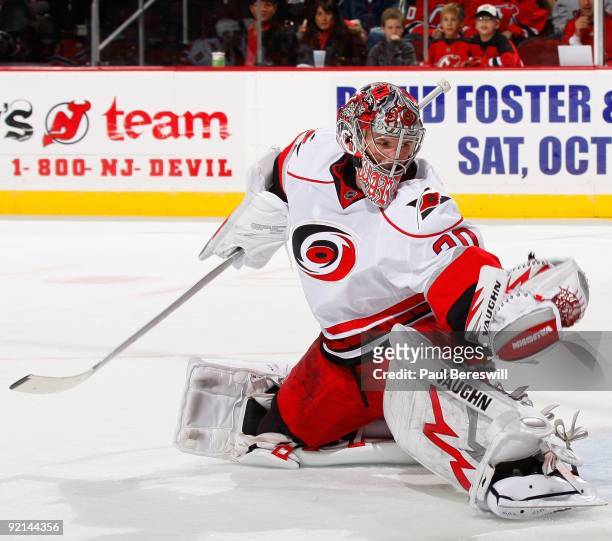 Goalie Cam Ward of the Carolina Hurricanes makes a save during a hockey game against the New Jersey Devils at the Prudential Center on October 17,...
