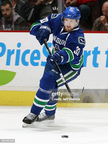 Henrik Sedin of the Vancouver Canucks passes the puck up ice during their game against the Columbus Blue Jackets at General Motors Place on October...