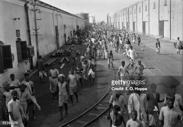 Workers exiting for lunch hour at the Birla Jute Mill in Calcutta , India, 1929.