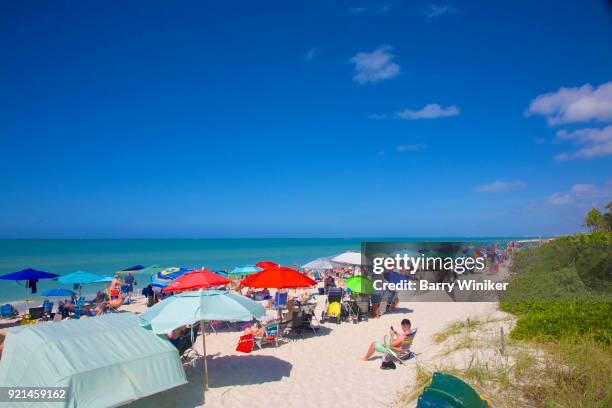 pristine white sand beach, colorful cabanas and umbrellas at vanderbilt beach, naples, fl - naples beach stockfoto's en -beelden