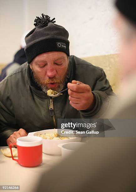 Thomas, a homeless man who has been unemployed since 1997, eats hot soup at a soup kitchen of the Malteser charity, part of the Order of Malta...