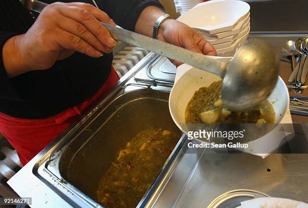 Workers of the Malteser charity, part of the Order of Malta Worldwide Relief, distribute hot soup to the needy at a Malteser soup kitchen on October...