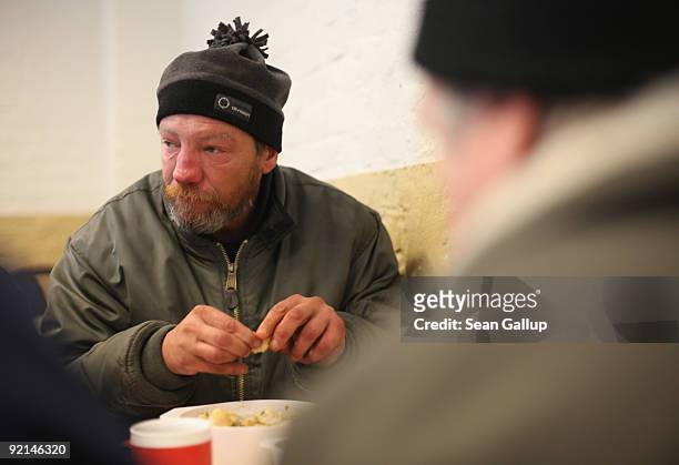 Thomas, a homeless man who has been unemployed since 1997, eats hot soup at a soup kitchen of the Malteser charity, part of the Order of Malta...