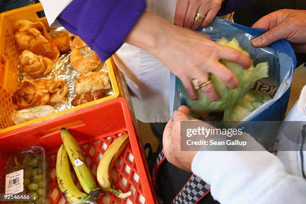 Worker of the Malteser charity, part of the Order of Malta Worldwide Relief, distributes groceries to the needy at a Malteser soup kitchen on October...