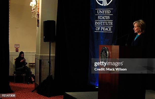 Secretary of State Hillary Clinton speaks while her aide Huma Abedin sits nearby off stage at the Mayflower Hotel on October 21, 2009 in Washington,...