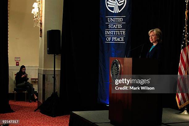 Secretary of State Hillary Clinton speaks while her aide Huma Abedin sits nearby off stage at the Mayflower Hotel on October 21, 2009 in Washington,...