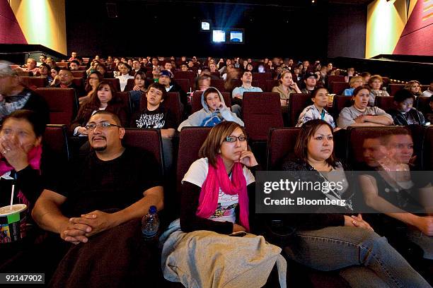 Movie-goers, from left, Michelle Vargas, Rudy Vargas, Brittany Vargas, Janelle Bonilla, and Tiffany McIntosh watch previews at a Harkins movie...