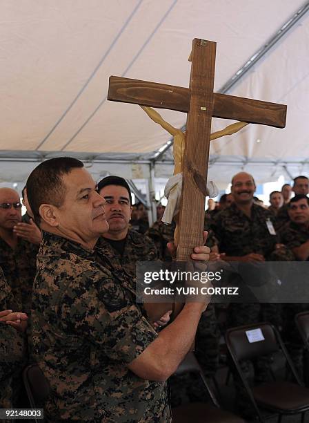 The Chief of the Honduran Armed Forces, General Romeo Vasquez, holds a crucifix during a mass to celebrate Army Day on October 21, 2009 in...