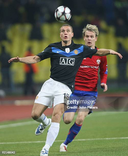 Nemanja Vidic of Manchester United is challenged by Milos Krasic of CSKA Moscow during the UEFA Champions League match between CSKA Moscow and...