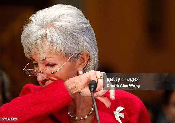 Secretary of Health and Human Services Kathleen Sebelius coughes onto her sleeve during a hearing before the Senate Homeland Security and...