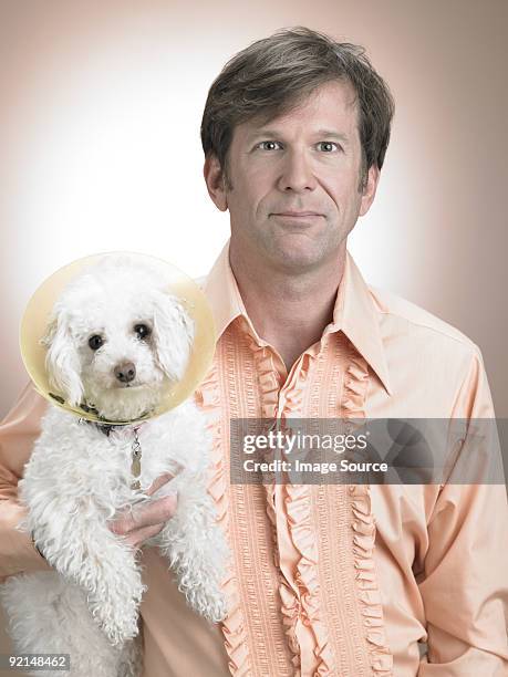 man with pet poodle - offbeat stockfoto's en -beelden