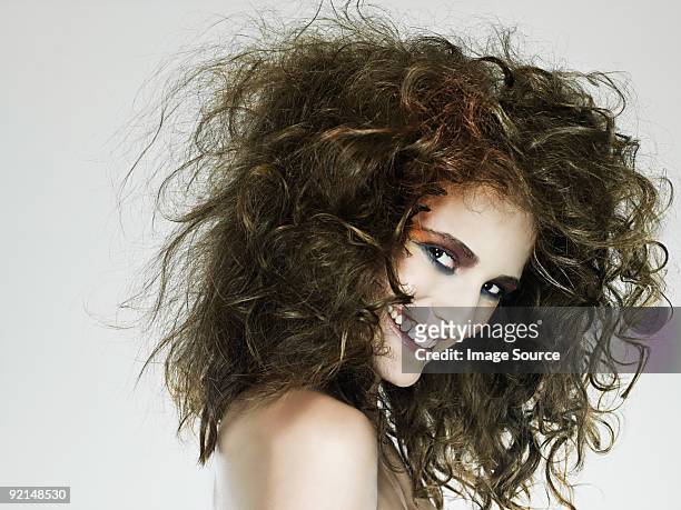 young woman with curly hair - cheveux au vent photos et images de collection
