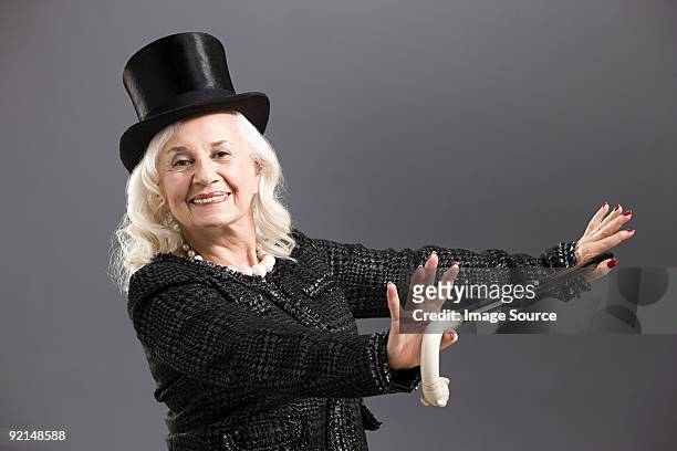senior mujer con sombrero de copa y caña - bastón para bailar fotografías e imágenes de stock