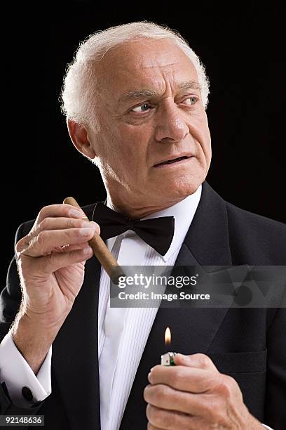 man in dinner jacket with cigar - premium lighter stock pictures, royalty-free photos & images