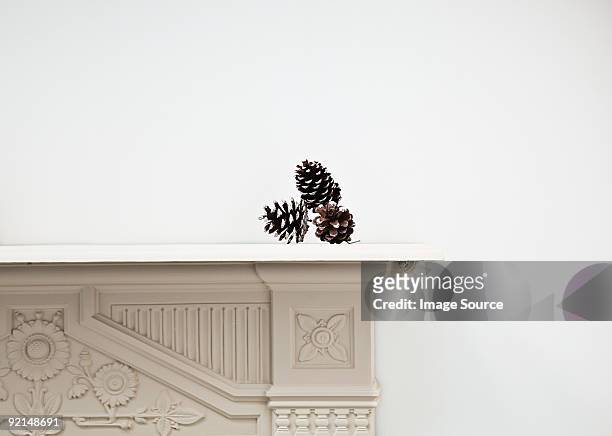 pine cones on mantlepiece - mantel stock pictures, royalty-free photos & images