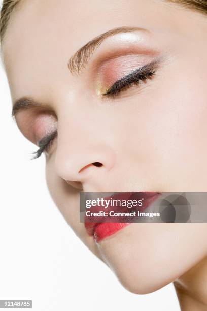 face of a young woman with eyes closed - kajalschminke stock-fotos und bilder
