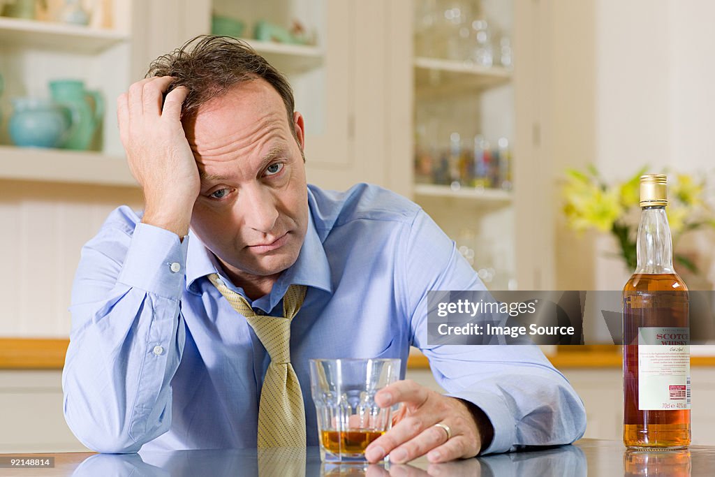 Stressed man with whisky