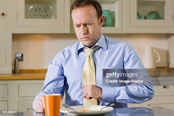 hombre con indigestión - high collar fotografías e imágenes de stock