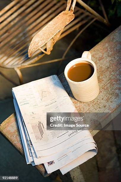 coffee cup and newspaper outdoors - newspaper on table stock pictures, royalty-free photos & images