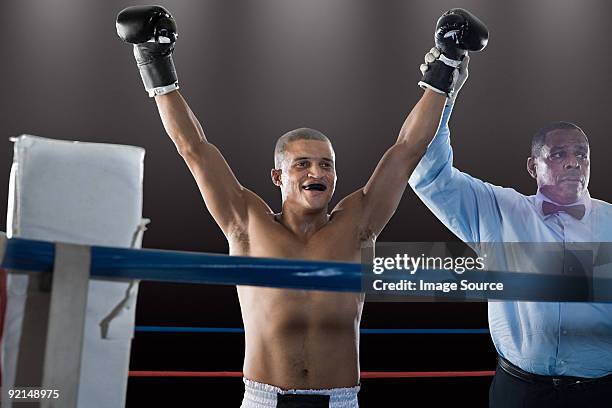 winning boxer and referee - man holding ring box stock pictures, royalty-free photos & images